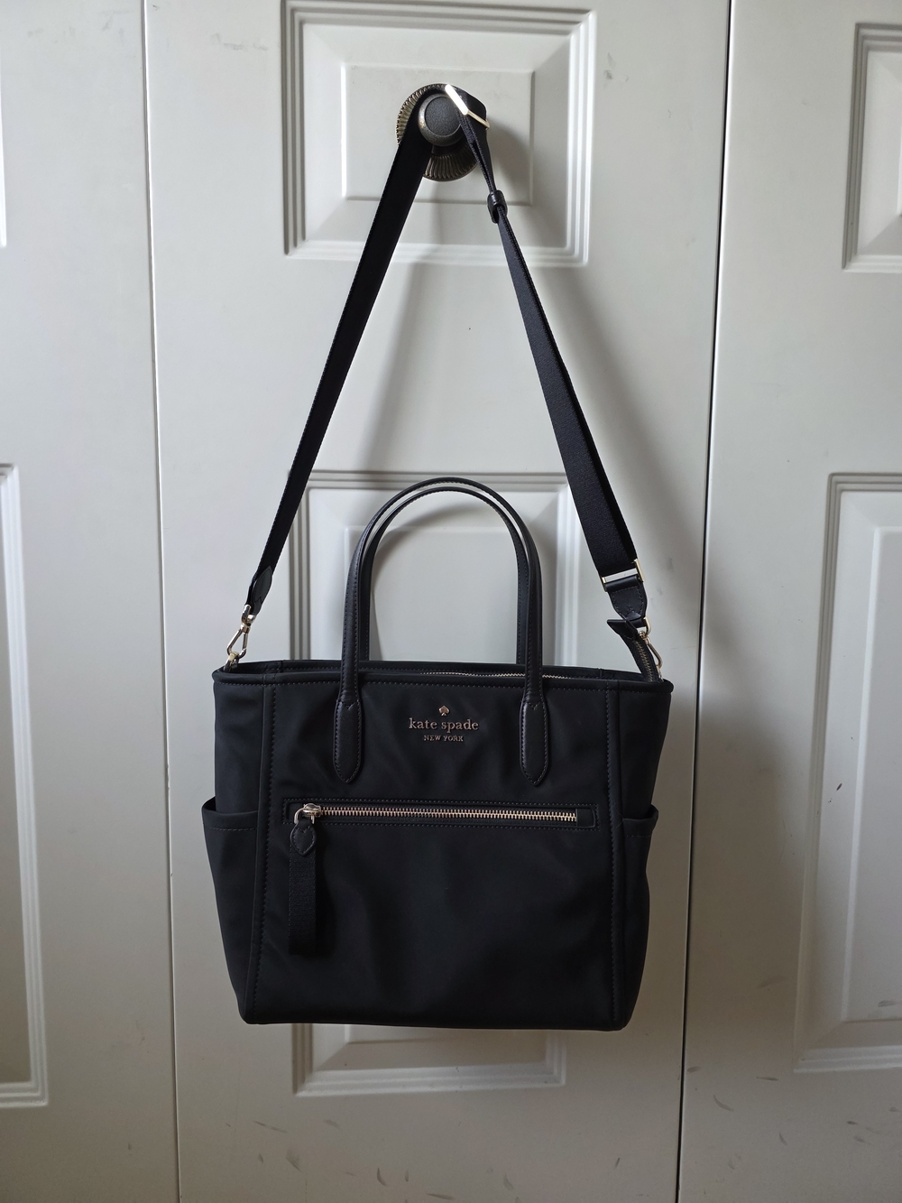 kate spade black tote with gold-tone logo and zipper
